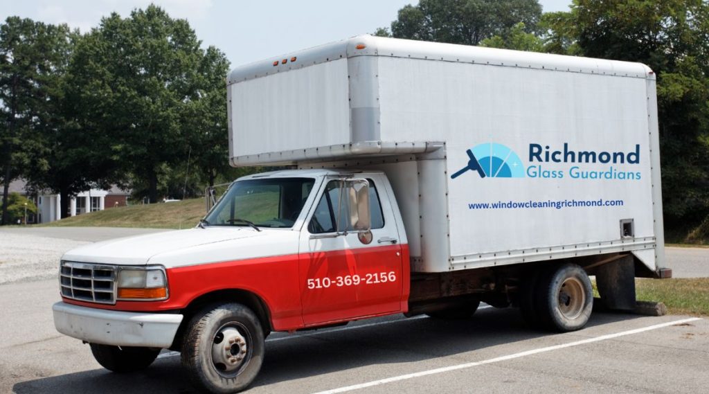 A truck marked with "Richmond Moving and Storage," including a contact number for window cleaning services.